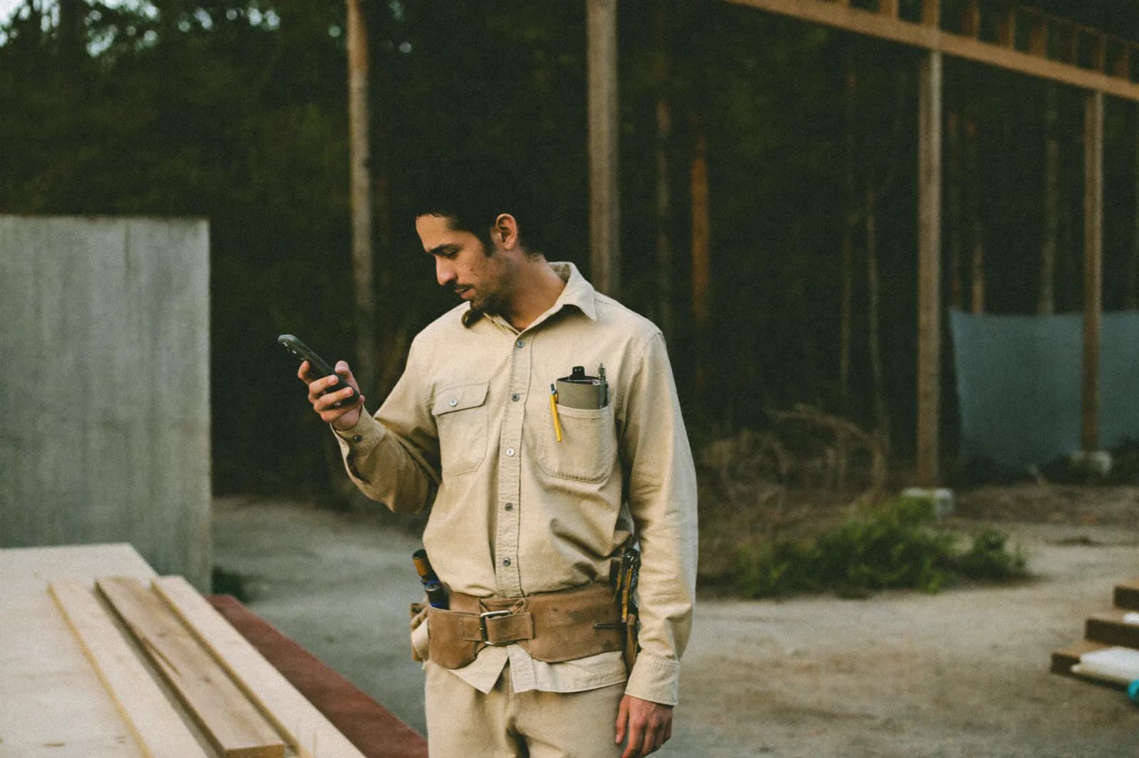 Contractor on a job site letting the platform answer a ringing phone